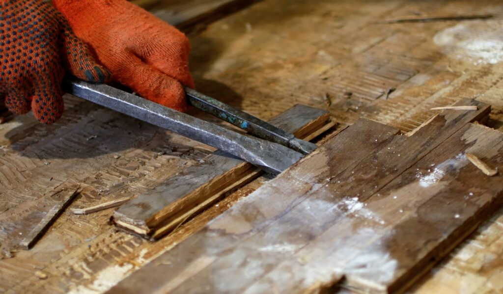 Manual dismantling of old wooden parquet